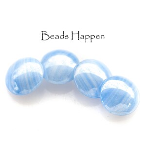 May include: Four light blue gemstone beads with a white striated pattern. Beads Happen.
