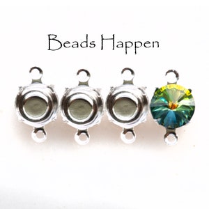 May include: Three silver-toned bead caps with two loops each, and one green and yellow faceted crystal bead.