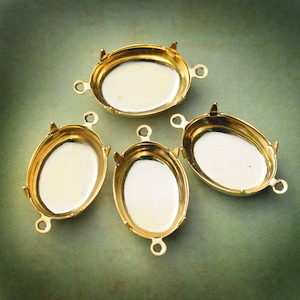 May include: Four gold-toned oval-shaped metal settings with three loops on each for attaching jewelry findings.