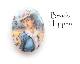 May include: Oval-shaped ceramic bead featuring a vintage image of a woman wearing a hat and a blue dress. The bead has a white background with the image printed on the front.