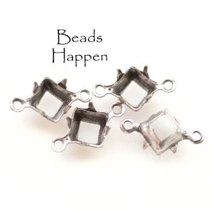 May include: Four silver-toned metal settings for bezel settings. Each setting has a square opening and two loops on the side. The text "Beads Happen" is visible in the background.