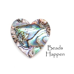 May include: A heart-shaped iridescent abalone shell pendant with a hole for stringing. The shell has a beautiful natural pattern of blues, greens, and browns.