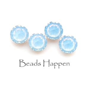 May include: Four light blue iridescent glass beads. The beads are round and have a faceted design. The beads are arranged in a row on a white background. The text "Beads Happen" is printed below the beads.