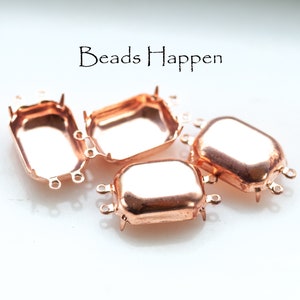 May include: Four copper-colored rectangular jewelry findings with small loops for attaching to other components. The text "Beads Happen" is in the upper right corner. These findings are ideal for jewelry making.