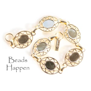 May include: Gold-toned bracelet with oval-shaped links, each featuring a delicate, openwork design. The bracelet has a clasp closure.