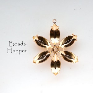 May include: Gold-toned metal flower charm with six petals and a hole in the center. The charm is designed for jewelry making.