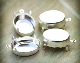 Puede incluir: Cuatro engastes ovalados de metal plateado con garras. Los engastes están diseñados para sujetar una piedra cabujón u otro adorno.