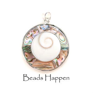 May include: A silver pendant with a white abalone shell in the center surrounded by a circular frame of iridescent abalone shell pieces. The pendant is on a white background.
