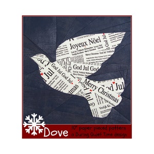 May include: A 10-inch paper pieced pattern for a dove, featuring a blue background and a white dove with the words "Merry Christmas", "God Jul", and "Joyeux Nöel" printed on it. The pattern is a During Quiet Time design.