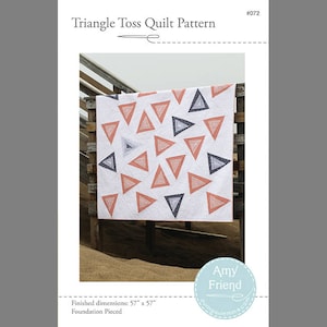 May include: A quilt pattern featuring a white background with a scattered design of pink and gray triangles. The quilt is 57 inches by 57 inches and is foundation pieced. The pattern is titled "Triangle Toss Quilt Pattern" and is numbered #072. The pattern is by Amy Friend and is available at SewingQuietTime.com.