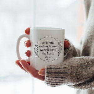 Puede incluir: Taza de cerámica blanca con un diseño circular negro que presenta el texto "As for me and my house, we will serve the Lord." y la referencia bíblica "Joshua 24:15".