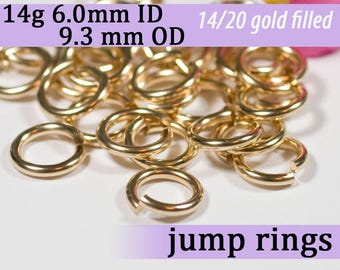 May include: A pile of 14 karat gold filled jump rings. The rings are 6.0 mm in inner diameter and 9.3 mm in outer diameter. 14/20 gold filled jump rings.