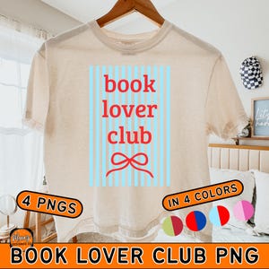 May include: Cream-colored t-shirt with the words "book lover club" in red, set against a light blue striped background. A red bow graphic is below the text. The shirt also has the text "4 PNGS" and "IN 4 COLORS".