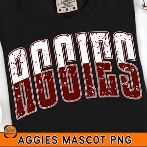 May include: Black t-shirt featuring the word "AGGIES" in large, distressed white and maroon lettering. The shirt has a crew neck and short sleeves. The text "AGGIES MASCOT PNG" is at the bottom of the image.