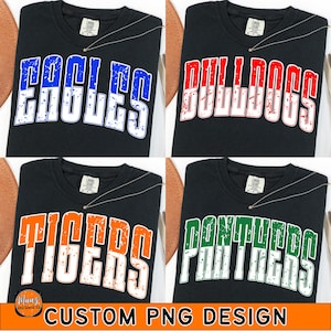 May include: Four black t-shirts with team names in bold, distressed lettering: Eagles (blue), Bulldogs (red), Tigers (orange), and Panthers (green). Each shirt has a small tag and a necklace. The bottom text reads "CUSTOM PNG DESIGN".