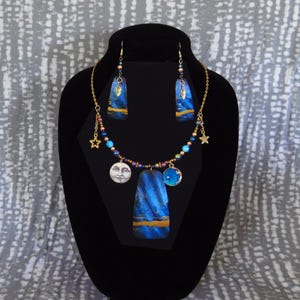 Astral Blue 1, blue and gold, gourd shard necklace, beads and charms, 19” length, with earrings