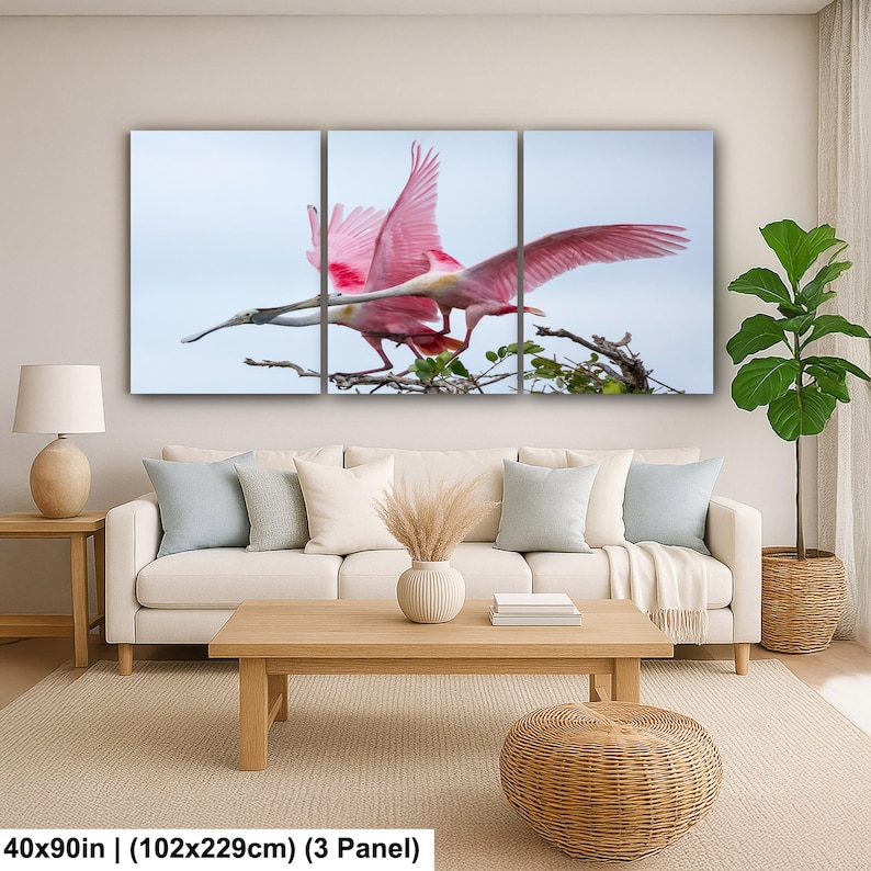 The image is a large, three-panel canvas print depicting a pink bird in flight, with a serene background of a tree branch and sky.