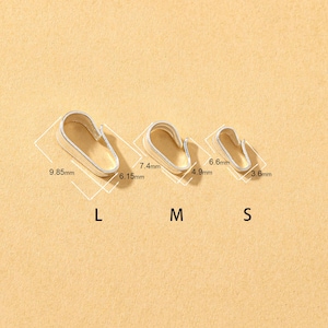 May include: Three silver metal clasps in different sizes, labelled L, M, and S. The largest clasp measures 9.85mm x 6.15mm, the medium clasp is 7.4mm x 4.9mm, and the smallest is 6.6mm x 3.6mm. The clasps are on a tan background.