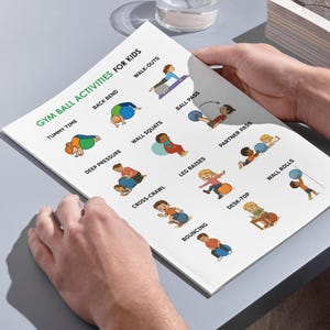May include: A book titled "GYM BALL ACTIVITIES FOR KIDS" with illustrations of children using gym balls for exercise. The book is open, showing various activities like 'Tummy Time' and 'Walk-Outs'. Measurements are in cm.