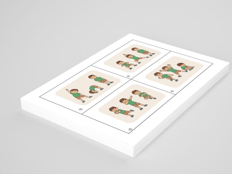 May include: A stack of white cards with illustrations of a person in various yoga poses. Each card features a beige background with a cartoon figure in a green shirt and brown shorts. The cards are stacked at an angle.