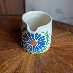Stoneware milk or cream jug with flower decoration