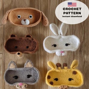 May include: A collection of crocheted animal-shaped trays, including a dog, bear, bunny, cat, giraffe, and a blue dog. The trays are in various colors and feature detailed facial features. The text "CROCHET PATTERN instant download" is in the upper right corner.