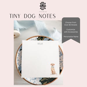 May include: A white notepad with the text "KELLIE" and a watercolor illustration of a golden retriever. The notepad is on a decorative plate with a floral design. The text "TINY DOG NOTES" is at the top.