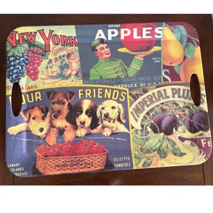 May include: Rectangular serving tray with vintage-style graphics. Features images of apples, grapes, plums, and puppies. Includes text that reads "New York," "Apples," "Our Friends," and "Imperial Plums." The tray has two handle cutouts.