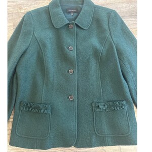 May include: A dark teal wool jacket with a rounded collar and three buttons. The jacket has two front pockets with ruffled trim and the brand name "Talbots" is visible on the collar.