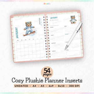 May include: Open planner with a pink cover, featuring a January calendar and weekly layout. Adorable bear illustrations in winter attire decorate the pages. A white pen rests on the right page. The planner has 54 pages.