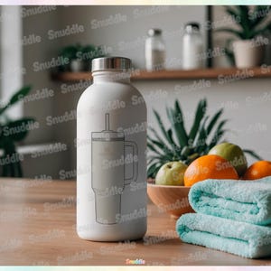 May include: A white insulated water bottle with a silver lid and a straw. A line drawing of a tumbler is on the bottle. A wooden bowl of fruit and folded blue towels are in the background.