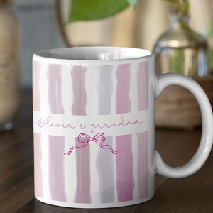 Puede incluir: Una taza de cerámica blanca con un asa negra y el texto "But First, Coffee" en negro y negrita. La taza está sobre una superficie de madera. La taza mide 10 cm de alto.
