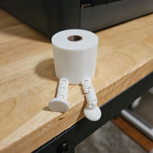 3D printed mini toilet paper with legs. Fun gag gift.