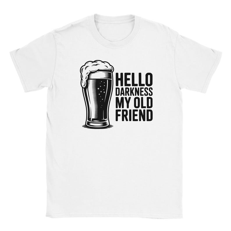 May include: White t-shirt featuring a black and white illustration of a beer glass with foam, and the text "HELLO DARKNESS MY OLD FRIEND". The design is centered on the shirt.