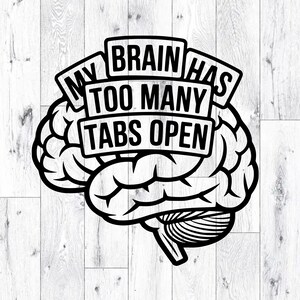 May include: Black and white graphic of a brain with the text "MY BRAIN HAS TOO MANY TABS OPEN" in a bold, sans-serif font. The brain illustration is detailed, with visible lobes and a stem. The design is set against a white wood-grain background.
