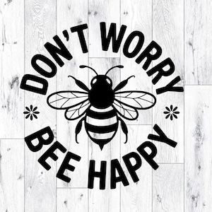 May include: Black and white graphic with the text "DON'T WORRY BEE HAPPY" in a circular design. A stylized bee is in the center, surrounded by the text and two small star shapes. The background is a light wood grain pattern.