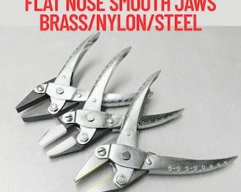 May include: Three parallel action pliers with flat nose smooth jaws. The pliers are made of brass, nylon, and steel. The text "Parallel Action pliers FLAT NOSE SMOOTH JAWS BRASS/NYLON/STEEL" is at the top of the image.