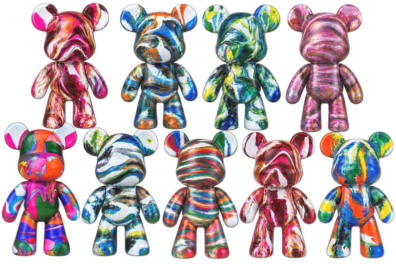 May include: A collection of nine bear-shaped figurines featuring various marbled and swirled paint patterns in vibrant colors including pink, blue, green, orange, and yellow. Each figure has rounded ears, a smooth surface, and a standing pose.