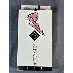 May include: A white box of SIGVARIS hosiery with a pink leg illustration. The box features the text "TOP FINE QUALITY" and the numbers "7 0 2". The style is "Half thigh / Grip-top" and the size is "Long".
