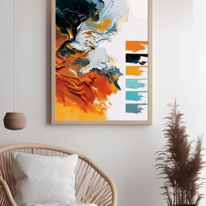 Peut inclure: Impression d'art abstrait dans un cadre en bois. L'œuvre présente un mélange de coups de pinceau orange, blanc, sarcelle et noir. Des échantillons de couleurs sont affichés à droite. L'impression est affichée au-dessus d'une chaise en osier avec un coussin blanc.