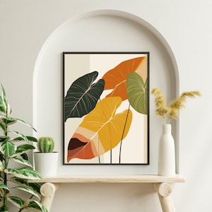 Könnte beinhalten: Gerahmter Kunstdruck mit stilisierten Blättern in Gelb-, Orange-, Grün- und Schwarztönen vor cremefarbenem Hintergrund. Das Kunstwerk wird auf einem Holzregal mit einer weißen Vase und einer Pflanze präsentiert.