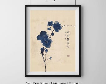 Op de afbeelding: Ingelijste kunstdruk met een aquarel van blauwe bloemen op een tak. Het kunstwerk heeft Japanse kalligrafie en een rode stempel. De print zit in een zwart frame, met de tekst "Quiet Paper Lab" bovenaan en "Art Designs | Posters | Prints" onderaan.
