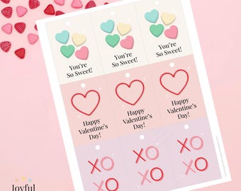 Könnte beinhalten: Ausdruckbare Valentinstag-Etiketten mit Herz- und Süßigkeiten-Grafiken. Die Etiketten zeigen die Sätze „You're So Sweet!“, „Happy Valentine's Day!“ und „XO XO XO“. Die Etiketten befinden sich auf einem rosa Hintergrund mit herzförmigen Süßigkeiten.