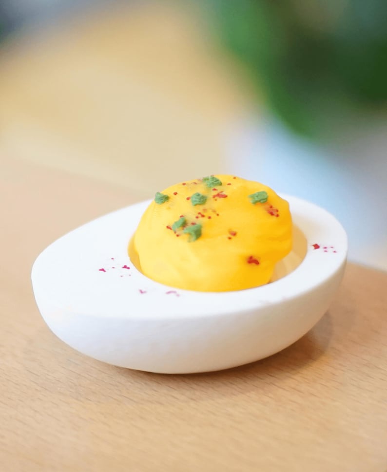 A fidget toy shaped like a deviled egg