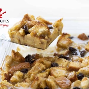 May include: A serving of bread pudding with raisins is lifted from a glass baking dish with a spatula. The dessert is golden brown and appears moist, with a creamy sauce and dark raisins throughout. The image includes the text "DIGARECIPES Digital recipes".