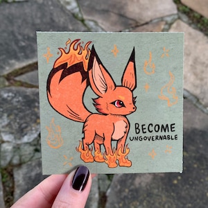 May include: A cartoon fox with orange fur and a fiery tail stands on flames. The text "Become Ungovernable" is written below the fox.