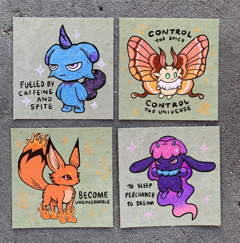 May include: Four illustrated cards with different cartoon characters and text. The first card features a blue creature with a horn and the text "Fueled by caffeine and spite". The second card features a pink and brown butterfly creature with the text "Control the spice, Control the universe". The third card features a fox-like creature with orange fur and flames and the text "Become ungovernable". The fourth card features a purple creature with a pink and purple tail and the text "To sleep perchance to dream".