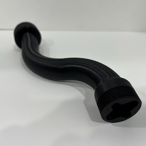 May include: A black plastic pipe with a curved shape and a threaded end. The pipe is designed for use in plumbing or other applications.