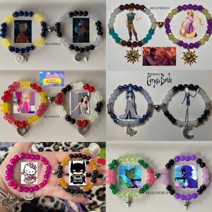 May include: A collection of magnetic couple bracelets featuring various character themes, including Coraline, Tangled, Barbie, Corpse Bride, Hello Kitty, Batman, and Teen Titans. Each bracelet is made of colourful beads with unique metal charms.