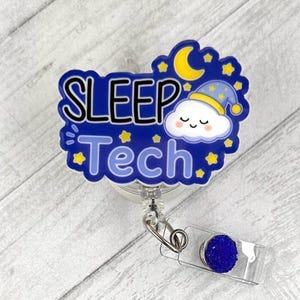 May include: A badge reel featuring a dark blue, cloud-shaped design with the text "SLEEP Tech" in black and light blue lettering. The design includes a yellow crescent moon, small yellow stars, and a white cartoon cloud wearing a blue nightcap.